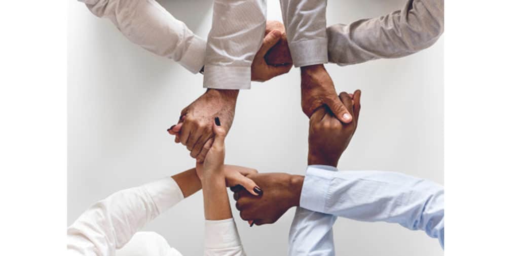 Image of handshake representing teamwork in social media marketing strategy. 